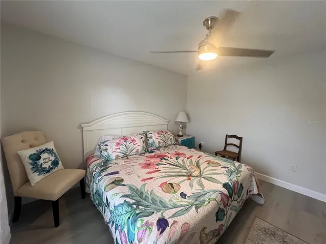 a bedroom with a bed and a chair