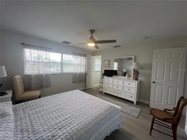 a bedroom with a large bed and a window