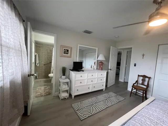 a room with a bed and a chair in it