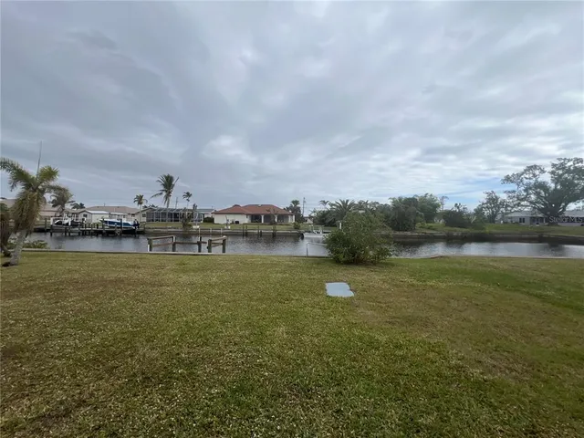 a view of a lake with houses in the back