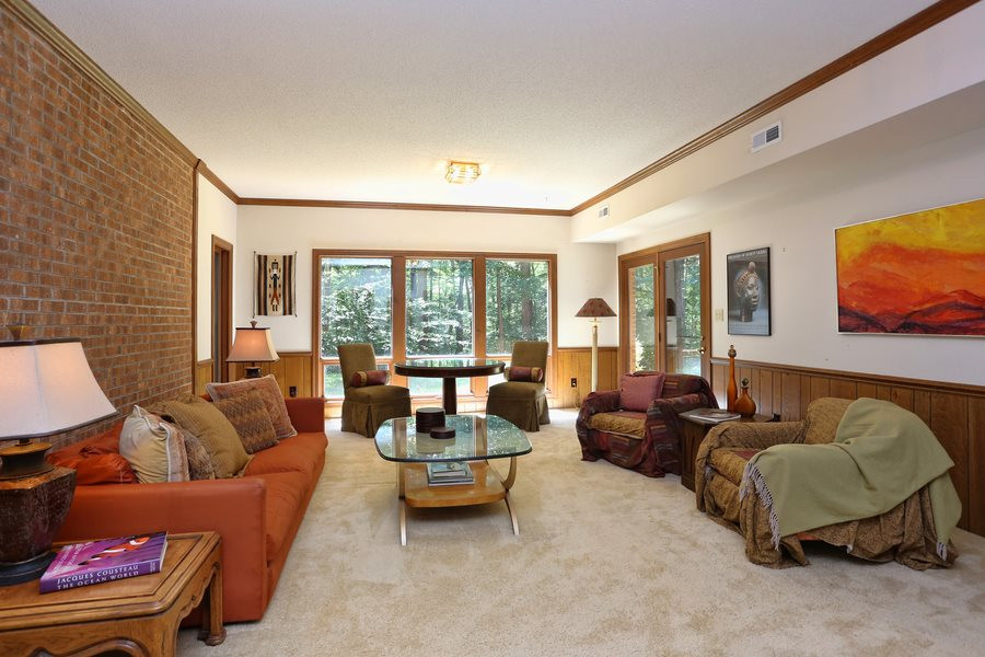 10420 Whitestone Road Raleigh, NC 27615 - Photo 16 of 24 Family fun and entertaining is a must in this family room! Check out the brick wall and tons of windows! The basement has huge bedroom and full bath, add a small kitchen and have yourself a mother-in-law suite. Basement Great Room