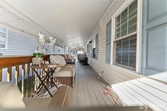 a balcony with furniture and wooden floor