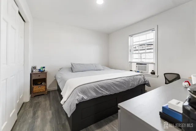 a bedroom with a bed and a night stand