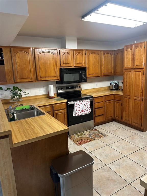 13220 225th Road Live Oak, FL 32060 - Photo 12 of 31 a kitchen with stainless steel appliances granite countertop a sink stove and refrigerator