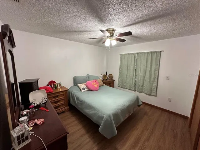 a bedroom with bed and a chandelier