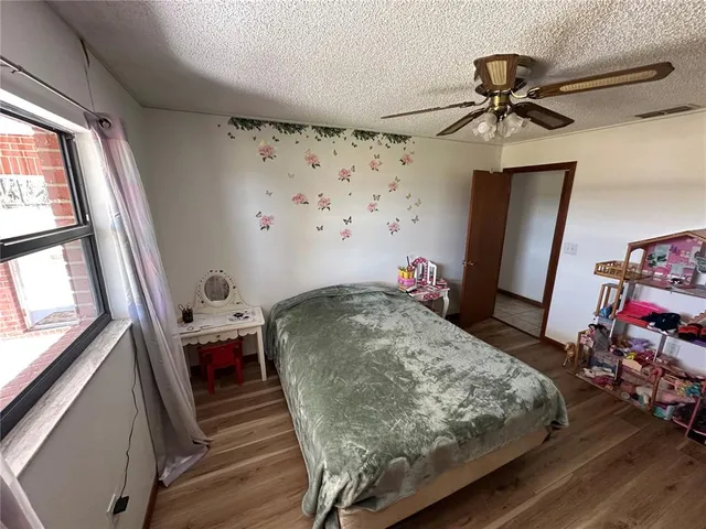 a bedroom with a bed and a mirror on the dresser