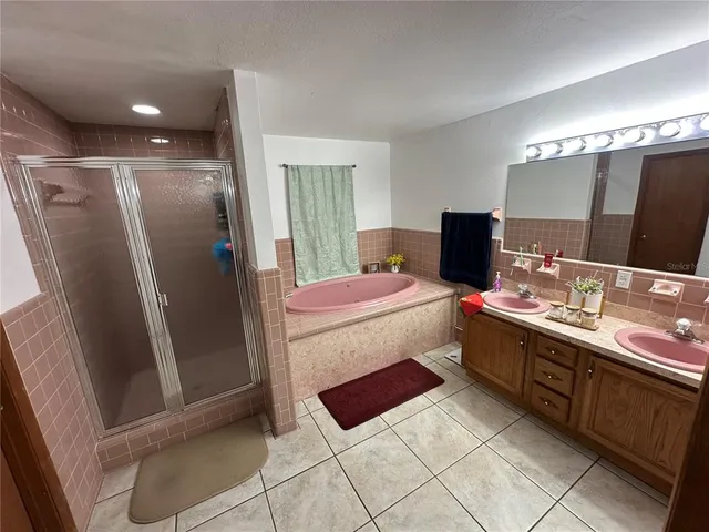 a bathroom with a double vanity sink and mirror
