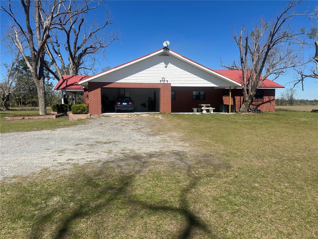 13220 225th Road Live Oak, FL 32060 - Photo 21 of 31 a front view of a house with a yard