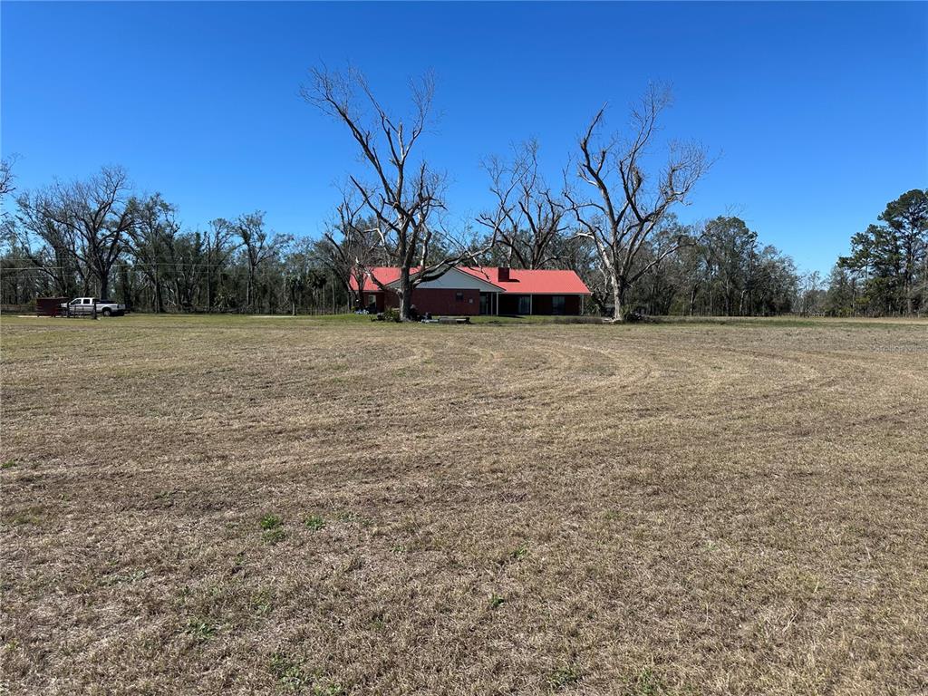13220 225th Road Live Oak, FL 32060 - Photo 23 of 31 a view of a field with some trees in front of it