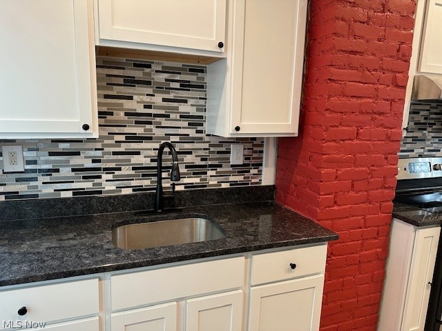 1388 Brookline Road Cleveland, OH 44121 - Photo 15 of 30 Kitchen featuring white cabinetry, sink, range with electric cooktop, and backsplash