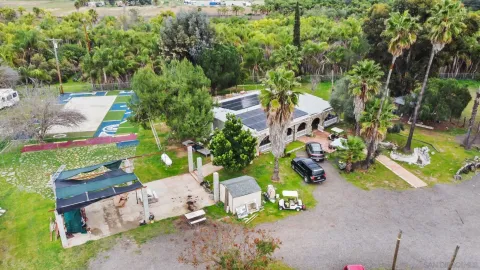 an aerial view of a house with a yard basket ball court and outdoor seating