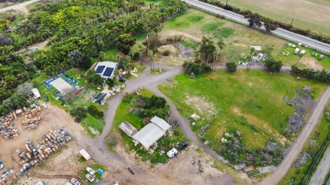 an aerial view of a house with a yard basket ball court and outdoor seating