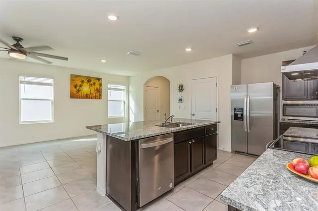 a view of kitchen with stainless steel appliances granite countertop refrigerator stove a sink and dishwasher