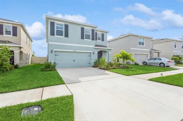 a front view of a house with a yard and garage