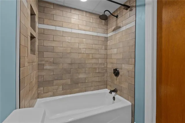 a bathroom with a bathtub and a shower
