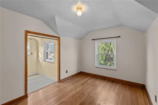 an empty room with windows and closet