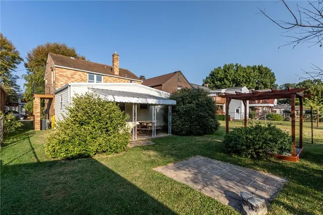 a front view of a house with a garden and plants