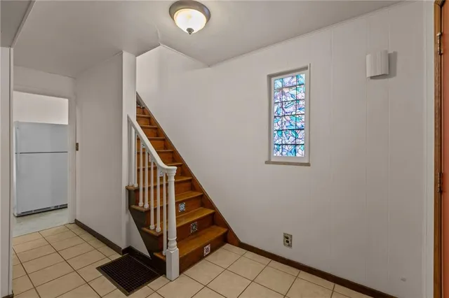 a view of entryway with stairs and wooden floor