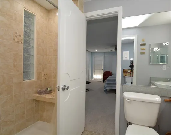 a bathroom with a toilet and a shower