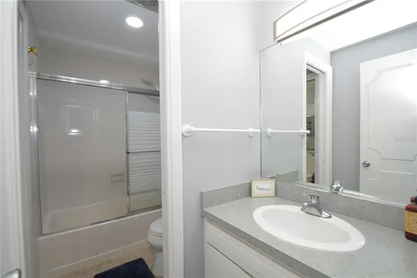 a bathroom with a shower a sink and a mirror