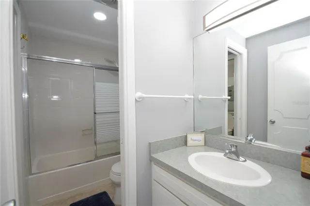 a bathroom with a shower a sink and a mirror