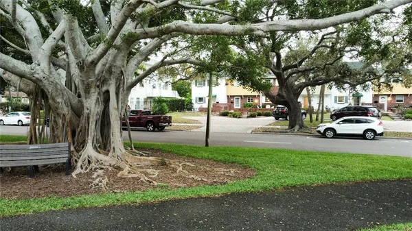 a view of a street with a building and trees