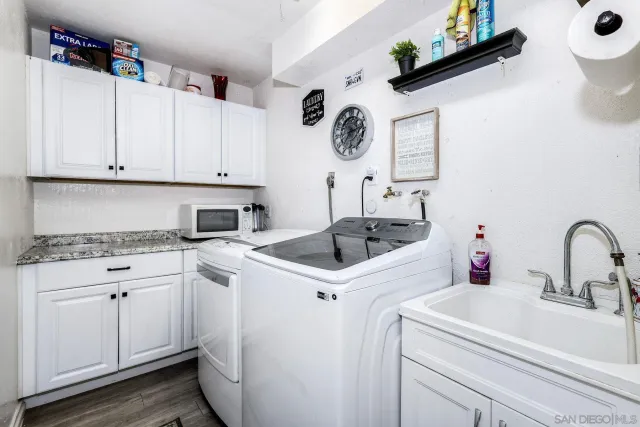 a kitchen with a sink a stove and cabinets