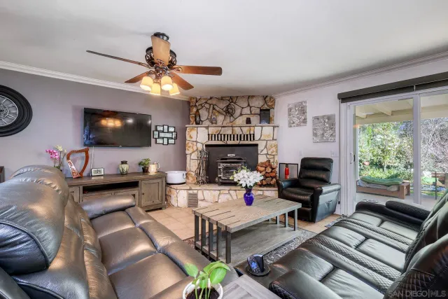 a living room with furniture a flat screen tv and a fireplace