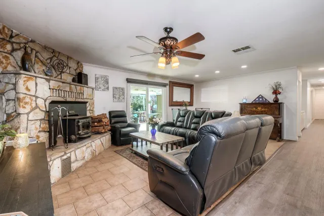 a living room with furniture ceiling fan and a fireplace