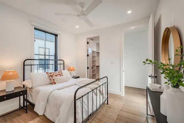 a bedroom with bed and a potted plant