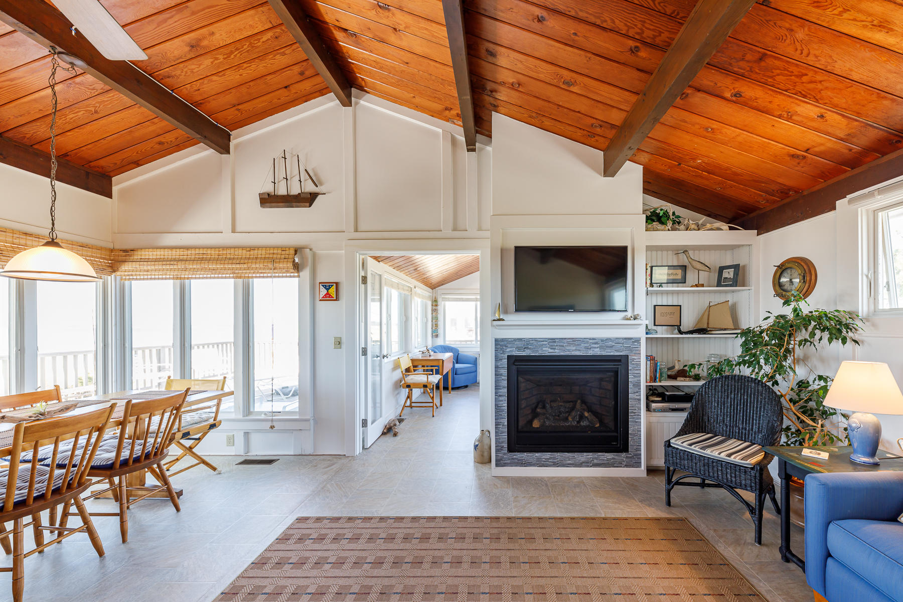 165 Harmes Way Eastham, MA 02642 - Photo 11 of 31 a living room with furniture a flat screen tv and a fireplace