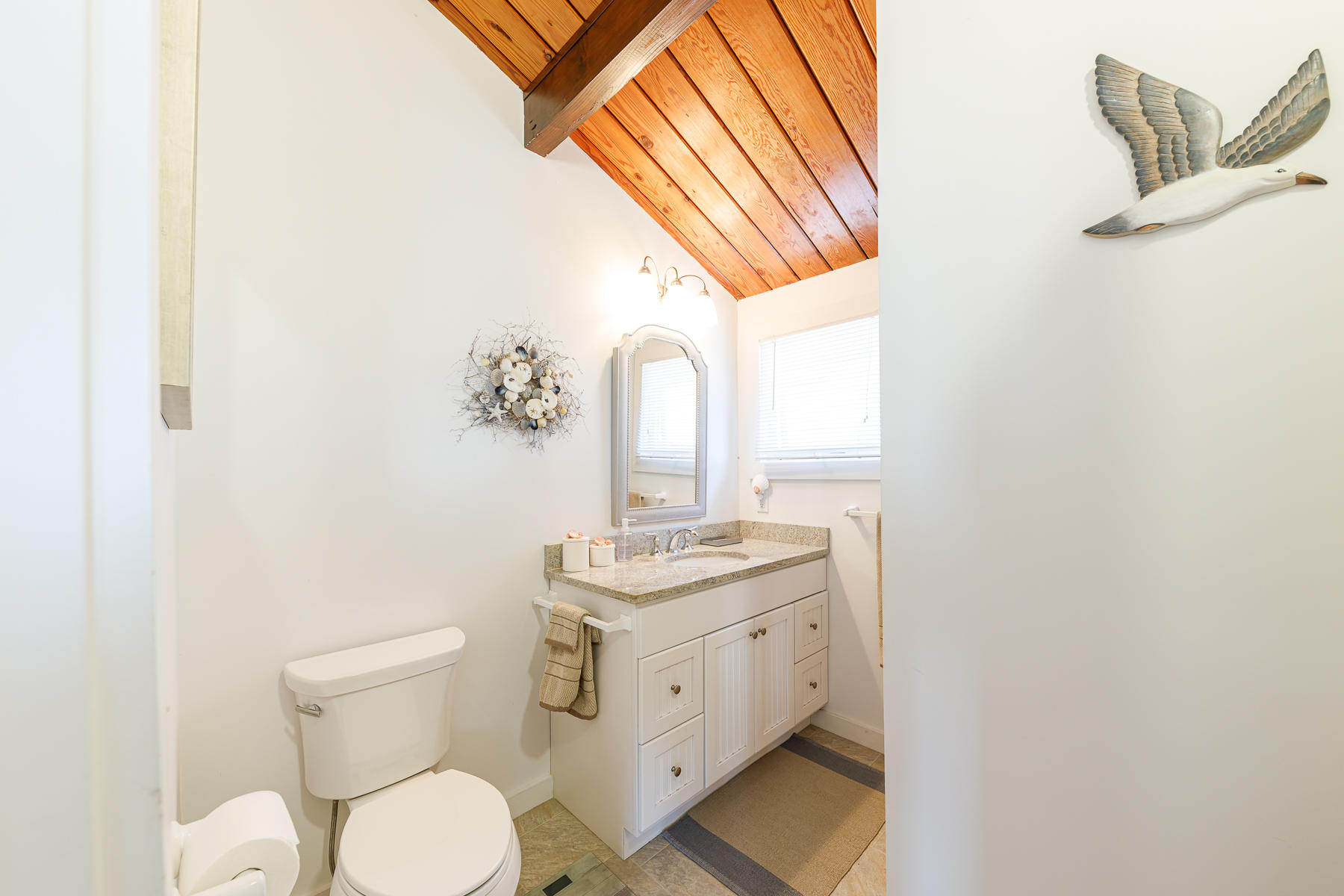 165 Harmes Way Eastham, MA 02642 - Photo 19 of 31 a bathroom with a toilet sink and mirror