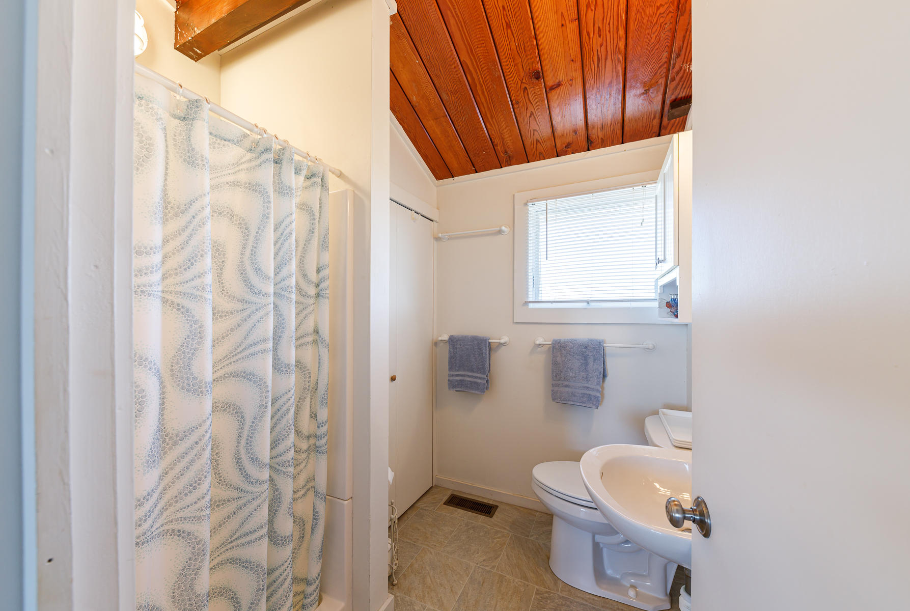 165 Harmes Way Eastham, MA 02642 - Photo 23 of 31 a bathroom with a toilet and a shower curtain
