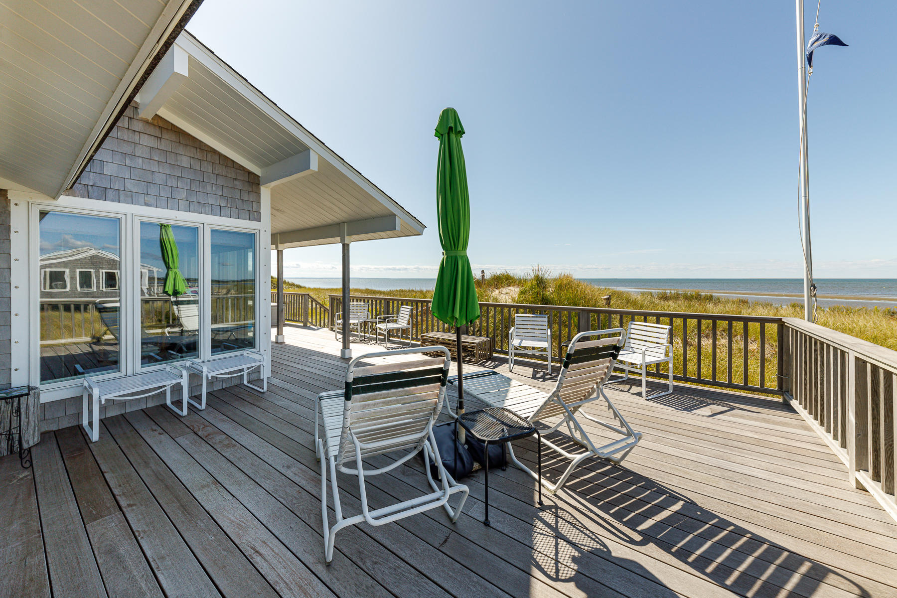 165 Harmes Way Eastham, MA 02642 - Photo 6 of 31 a view of a balcony with chairs and wooden floor