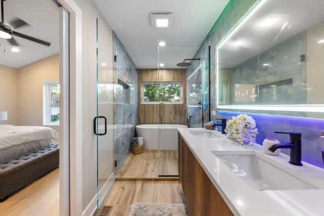a bathroom with a tub sink and mirror