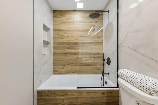 a bathroom with a bathtub and shower