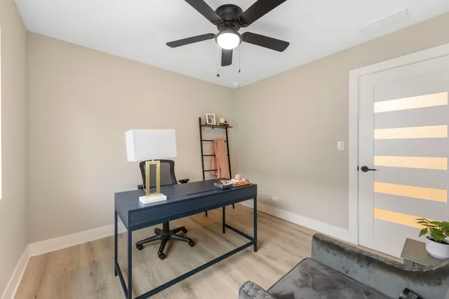 a view of a workspace with furniture and a window