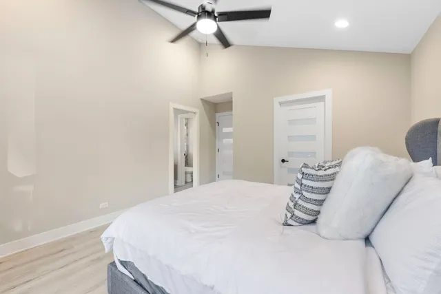 a bedroom with a bed and chair