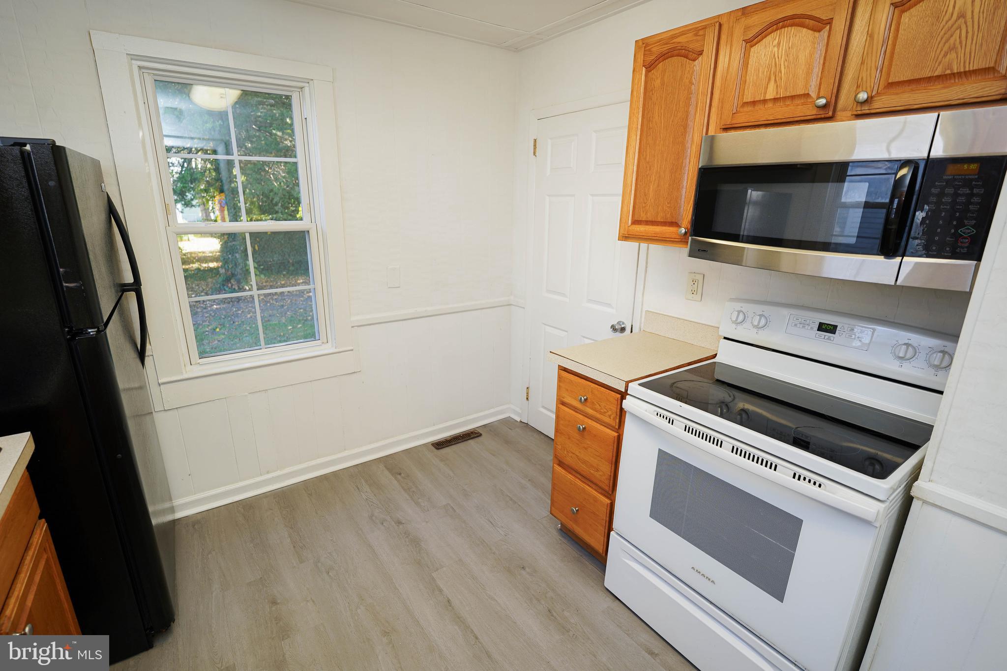 509 State Street Seaford, DE 19973 - Photo 13 of 31 a kitchen with a stove microwave and sink