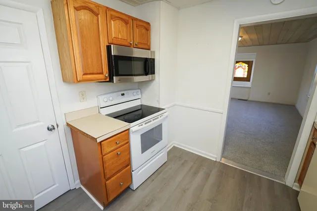 storage and utility room with wooden floor