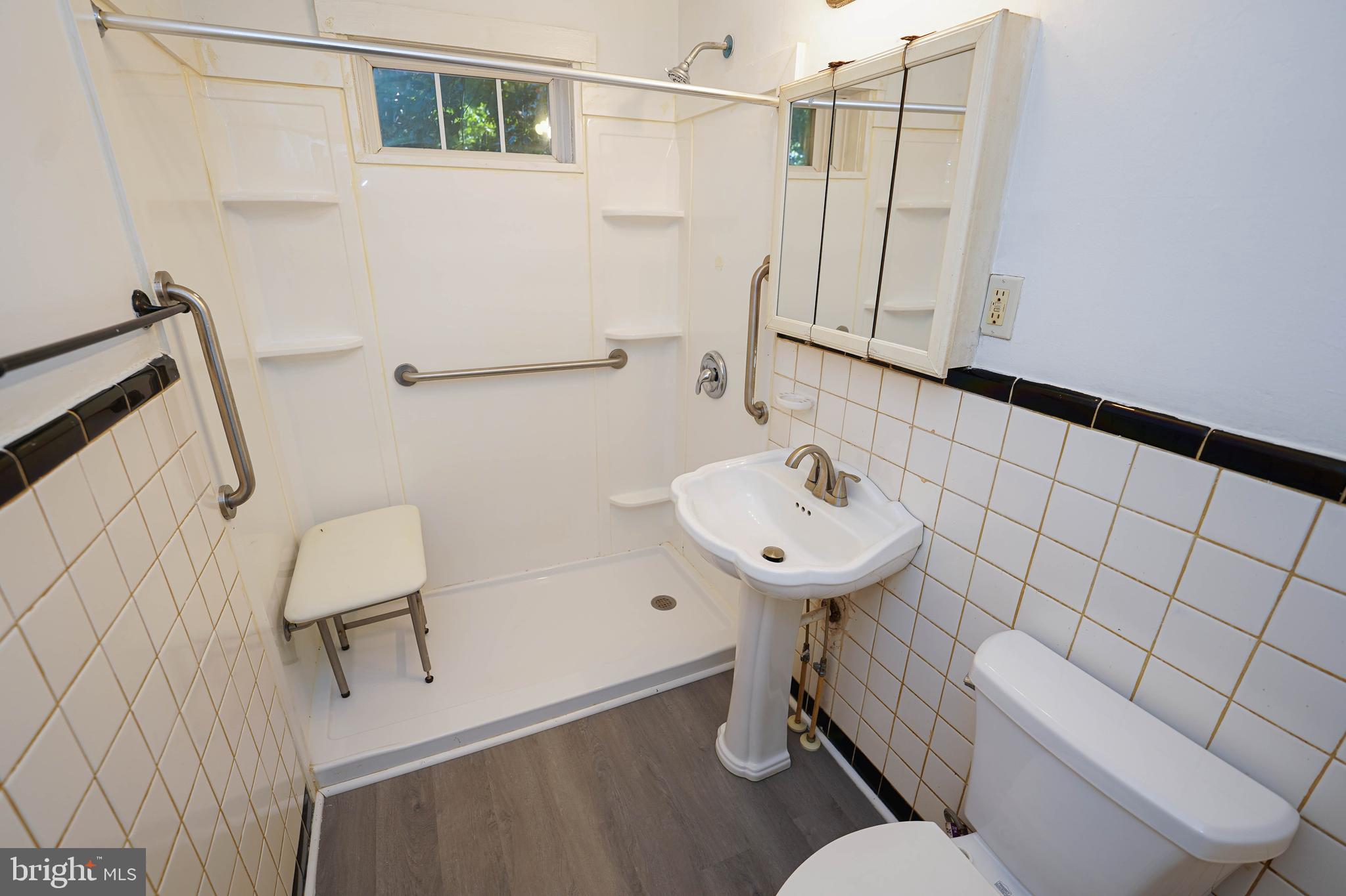 509 State Street Seaford, DE 19973 - Photo 24 of 31 a bathroom with a sink a toilet and shower