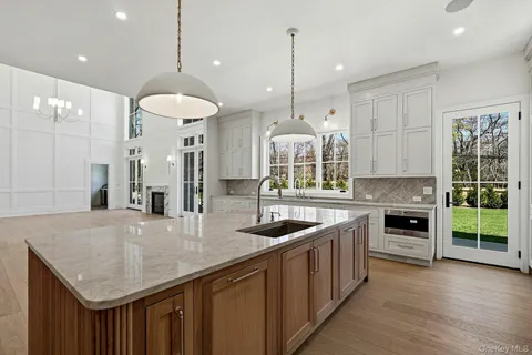 a dining room with furniture a chandelier and wooden floor