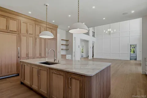 a kitchen with a sink a cabinets and wooden floor
