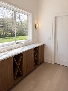 a spacious bedroom with a large bed and a chandelier
