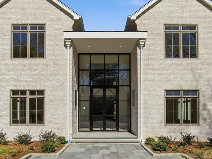 a front view of a house with a window and a potted plant