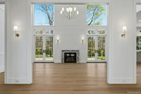 a view of a big room with kitchen and chandelier