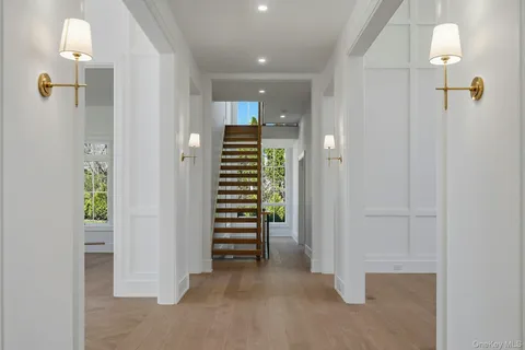 a large kitchen with a large counter top a sink stainless steel appliances and cabinets