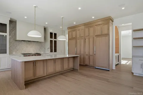 an open kitchen with a sink and chandelier