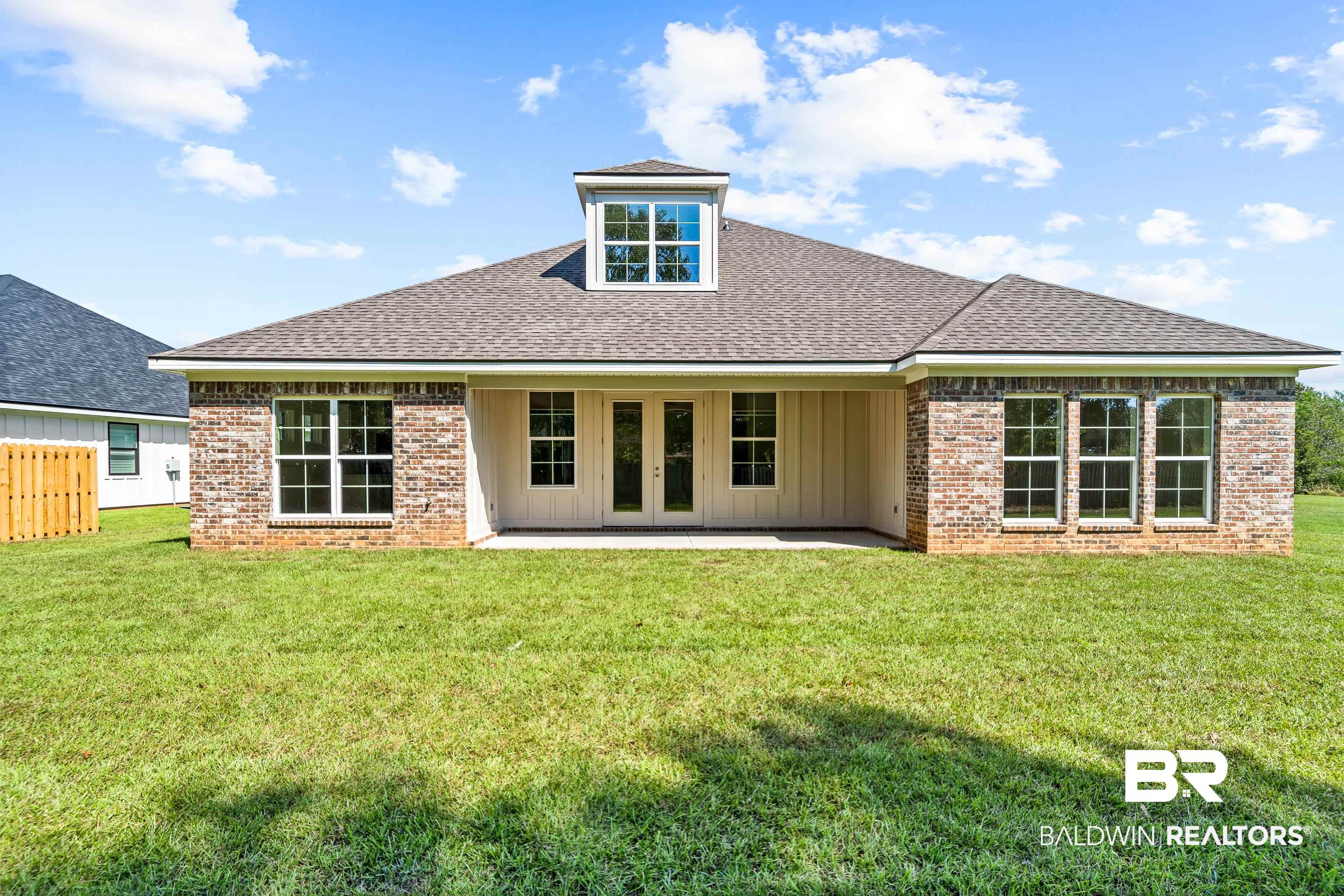 25927 Capra Court Daphne, AL 36526 - Photo 31 of 37 Back of house featuring french doors, a yard, and a patio