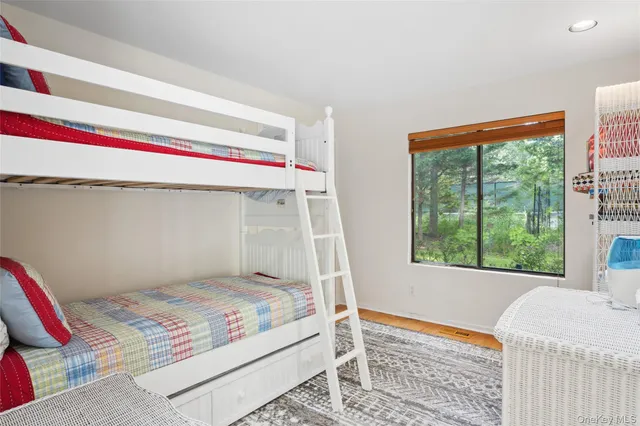 a bedroom with a bed and a large window